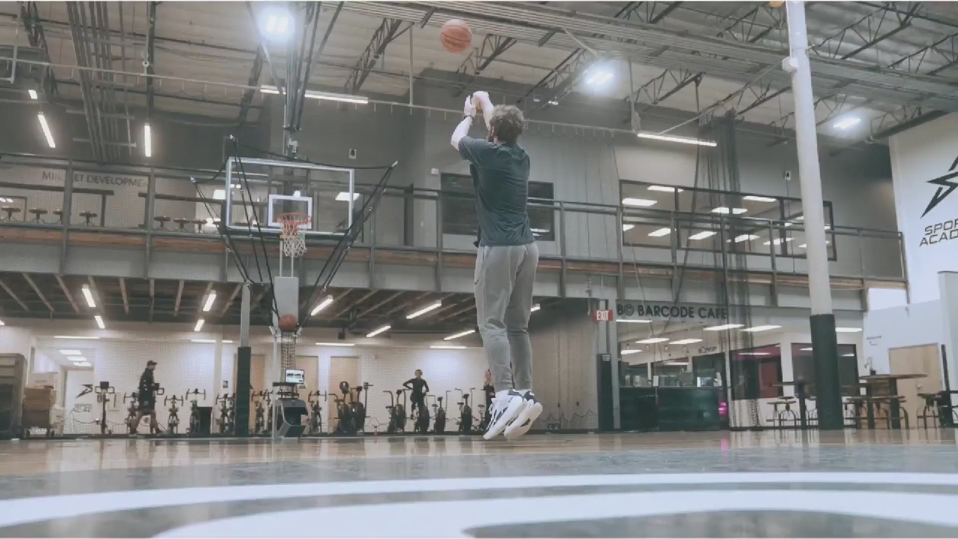 Load video: Basketball player using Hoopfit in driveway.